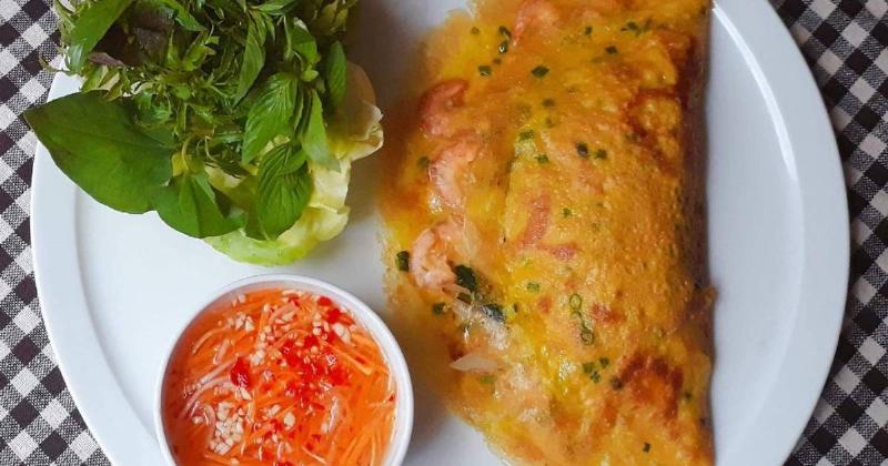 Hình ảnh đĩa ram cuốn cải Hà Tĩnh, thể hiện ram giòn được cuốn trong lá cải bẹ xanh với các loại rau sống, trái cây chua chát, và chén nước chấm, đặc trưng ẩm thực vùng miền nào này